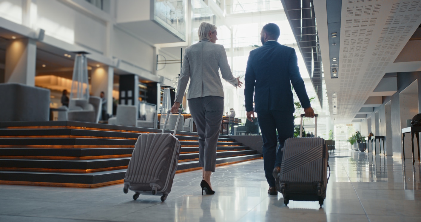 Travel, suitcase and business people in airport lobby for global collaboration, teamwork and professional negotiation with wealth, luxury and rich. Corporate lawyer team in suit and luggage at hotel